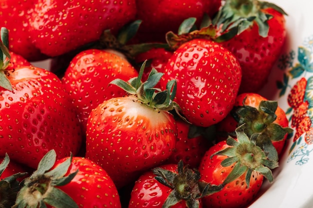 Fresh ripe juicy strawberries in a bowl closeup