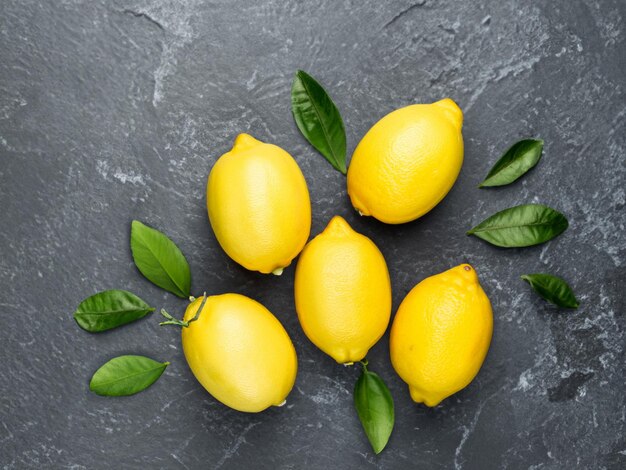 Fresh ripe lemons on dark stone background Top view with copy space