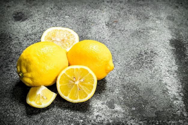 Fresh ripe lemons . On a rustic background.