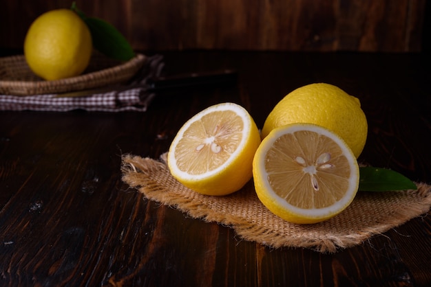 Fresh ripe lemons with copy space on wooden table. 