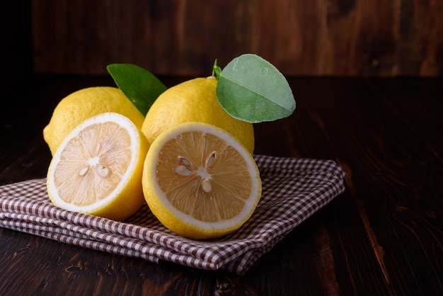 Fresh ripe lemons with copy space on wooden table. 