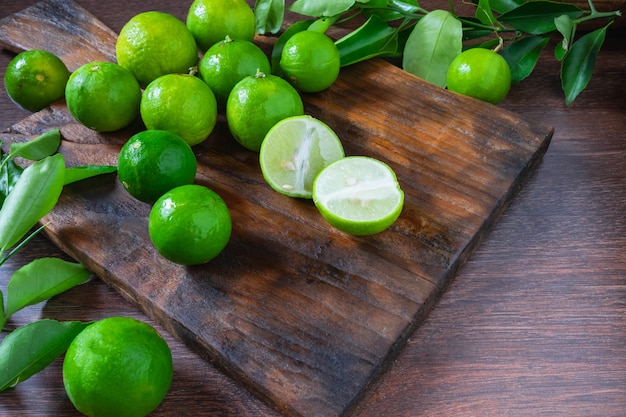 Fresh ripe limes on wooden background