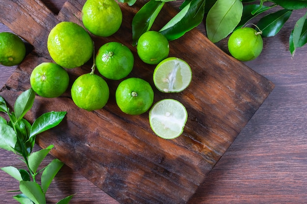 Fresh ripe limes on wooden background