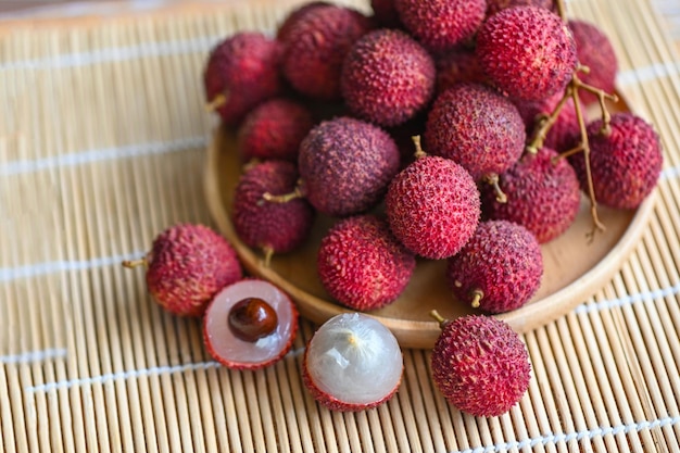 Fresh ripe lychee fruit tropical fruit peeled lychees slice in Thailand lychees on wooden plate