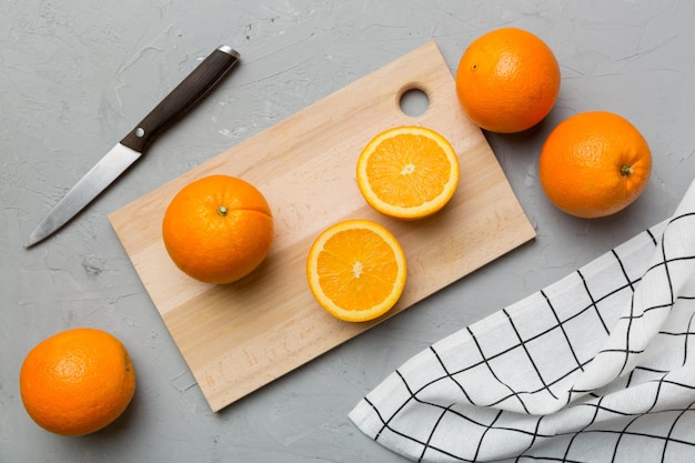 Fresh ripe oranges on cutting board on table Top view Flat lay