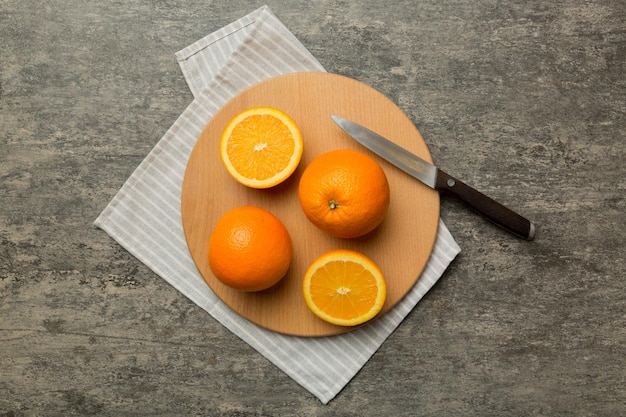 Fresh ripe oranges on cutting board on table Top view Flat lay