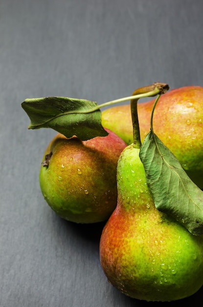 Fresh ripe pears on black