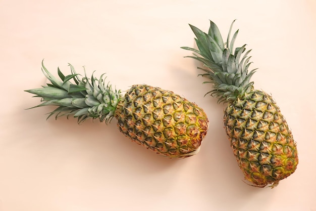 Fresh ripe pineapples on color background top view