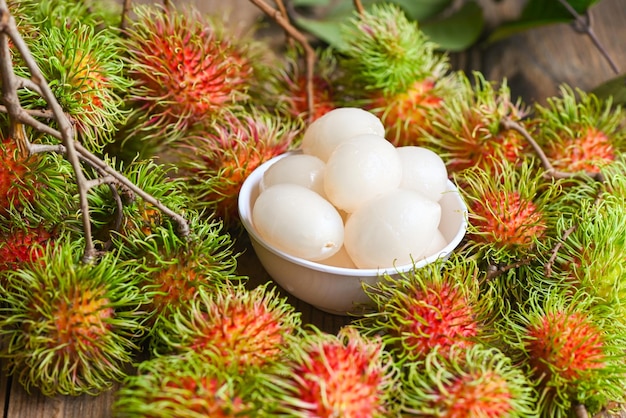 Fresh and ripe rambutan sweet tropical fruit peeled rambutan with leaf Rambutan fruit harvest from the garden rambutan tree