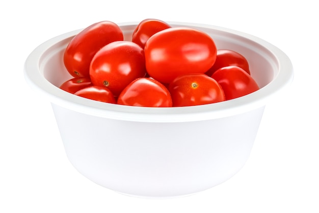 Fresh and ripe red cherry tomatoes in a disposable white bowl made of biodegradable materials isolated on white background