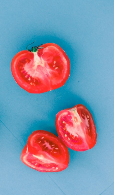 Fresh ripe red tomatoes on blue background organic vegetable food