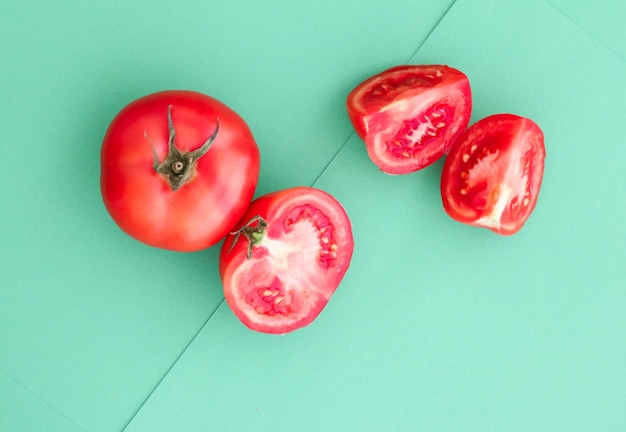 Fresh ripe red tomatoes on green background organic vegetable food