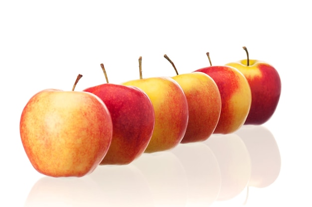 Fresh ripe red and yellow apples on white background