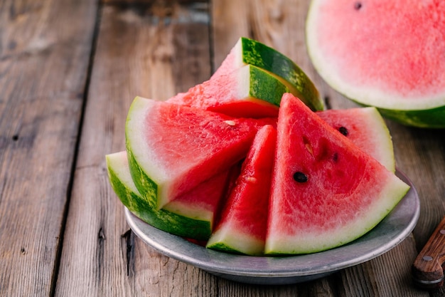 Fresh ripe sliced watermelon on wooden rustic background