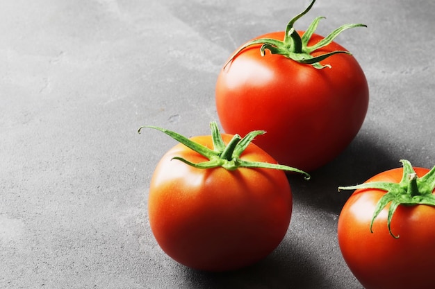 Fresh ripe tomatoes on a concrete background Top view View from above