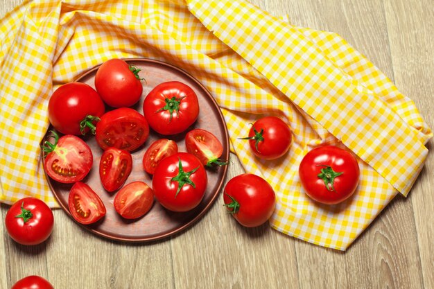 Fresh ripe tomatoes on a wooden background