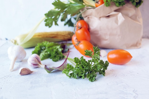 Fresh ripe variety of vegetables and greens in an ecological paper bag