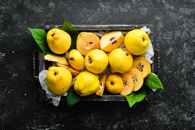 Fresh ripe yellow quince Fruits in a wooden box Top view Free space for text