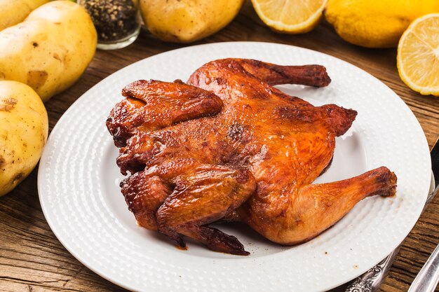 Fresh roast chicken on a wooden board background