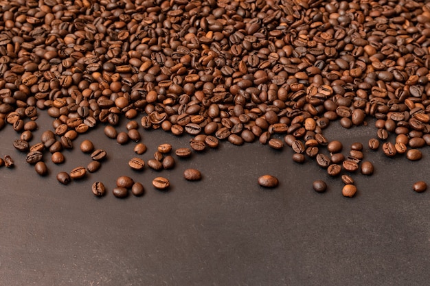 Fresh roasted coffee beans on dark background selective focus