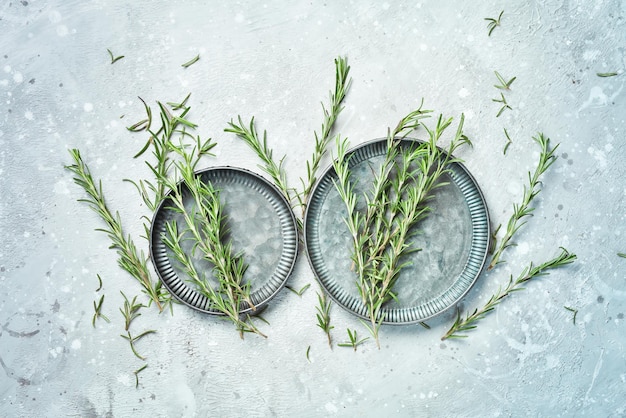 Fresh rosemary Aromatic spices On a stone background Top view