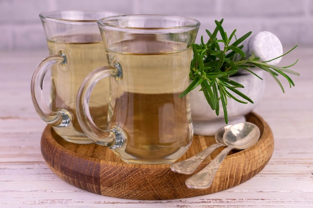 Fresh rosemary tea. Herbal tea in a transparent cup.