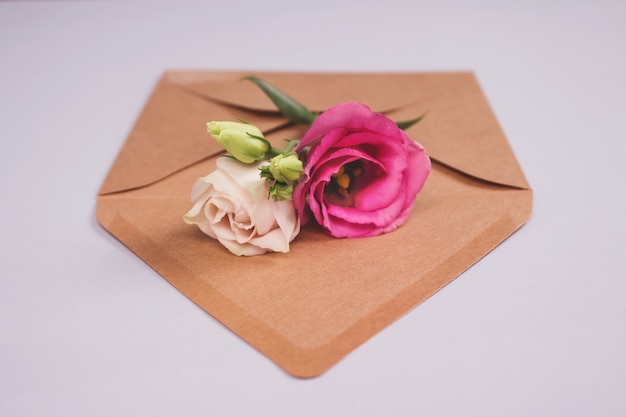 Fresh roses on kraft paper envelope