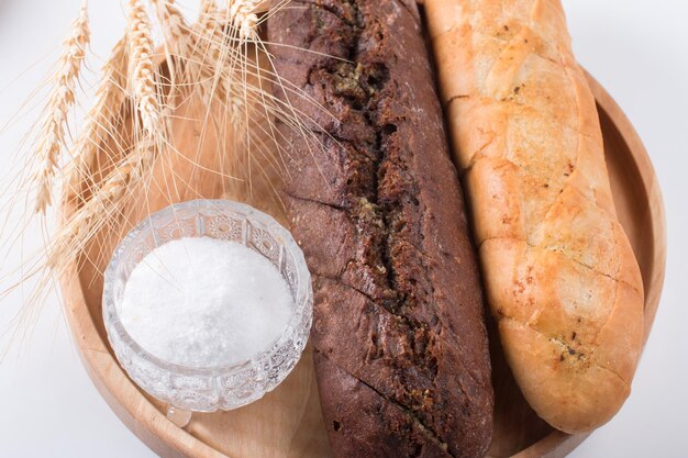 Fresh round black bread with a crispy crust garlic baguette white and black Closeup on a white background