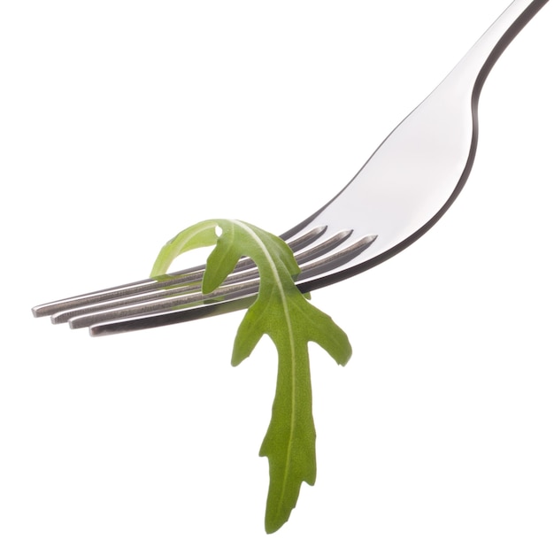 Fresh rucola salad on fork isolated on white background cutout Healthy eating concept