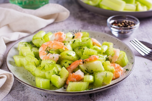 Fresh salad of celery and shrimp on a plate for a vegetarian diet