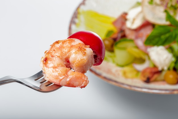 Fresh salad plate with shrimp, tomato and mixed greens