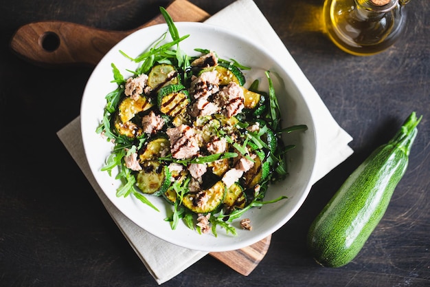 Fresh salad with arugula baked zucchini and tuna the concept of healthy and nutritious food