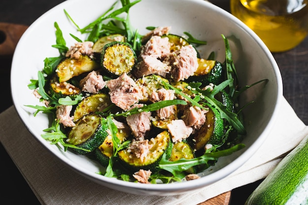 Fresh salad with arugula baked zucchini and tuna the concept of healthy and nutritious food