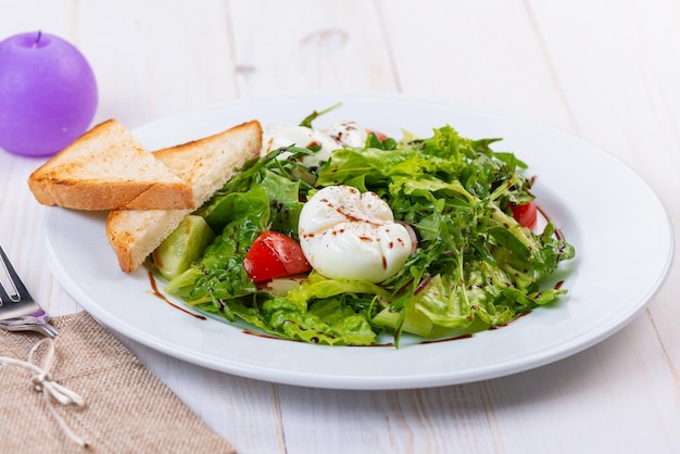 Fresh salad with arugula tomato and egg