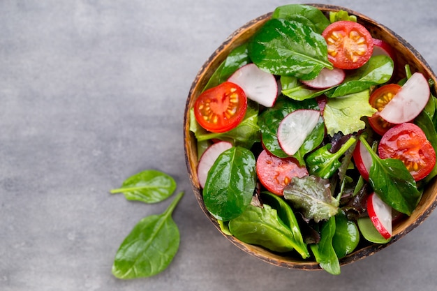 Fresh salad with baby spinach and tomato, radish und salad.