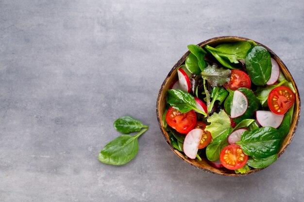 Fresh salad with baby spinach and tomato, radish und salad.