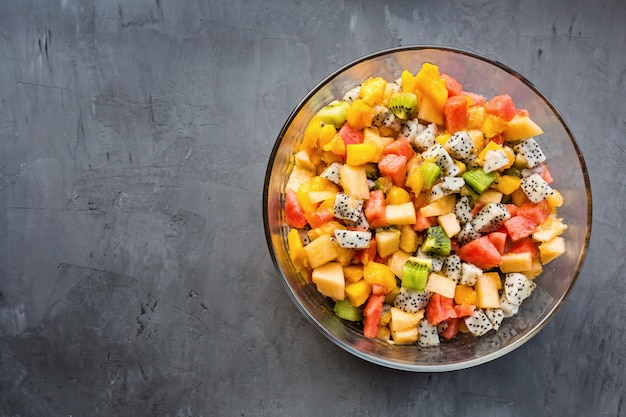 Fresh salad with exotic fruits closeup 