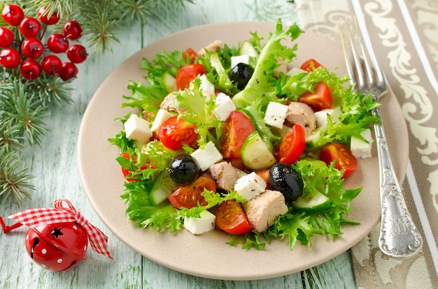 Fresh salad with tuna, tomatoes and cucumbers on lettuce leaves