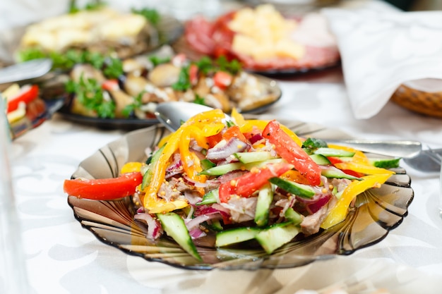 Fresh salads on a banquet table, shallow depth of field