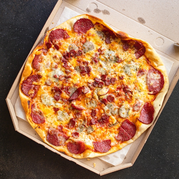 Fresh salami pizza with cheese and sausages