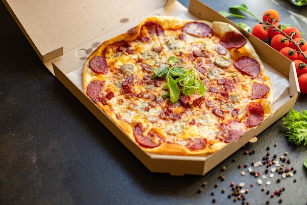 Fresh salami pizza with cheese and sausages