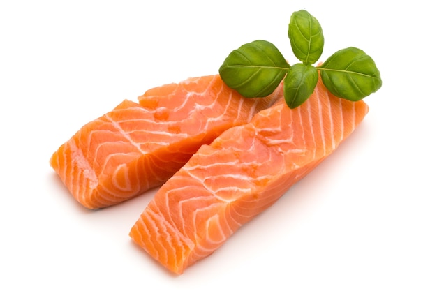 Fresh salmon fillet with basil on the white background