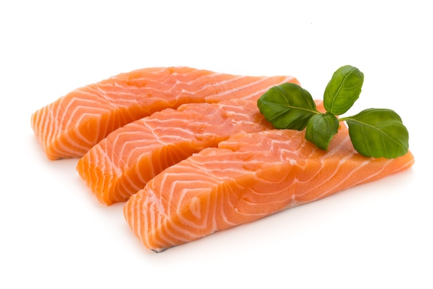 Fresh salmon fillet with basil on white.