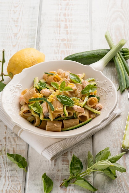 Fresh salmon pasta with zucchinis leek and grated lemon peel