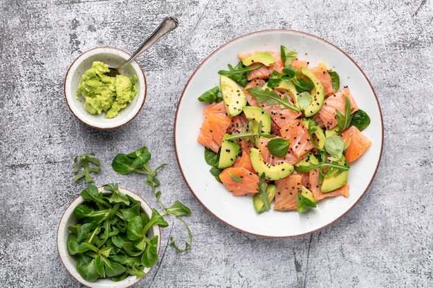 Fresh salmon salad with avocado,  for keto and low carb diet. Rusty background, top view, copy space.