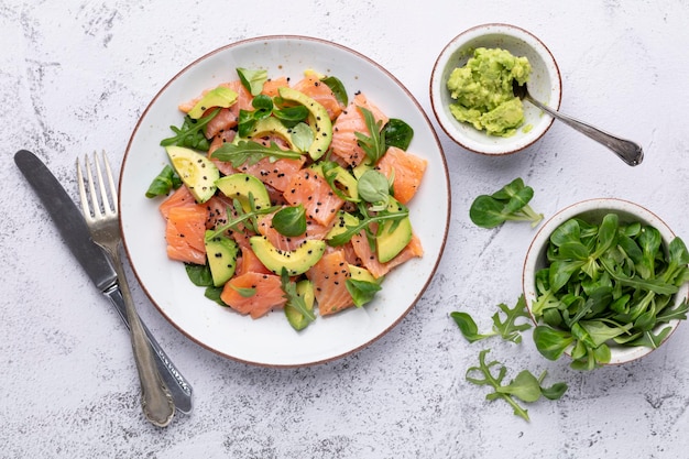 Fresh salmon salad with avocado  for keto and low carb diet Rusty background top view copy space