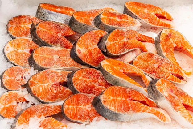 Fresh salmon steaks on ice on the counter Health vitamins and healthy food Top view Closeup