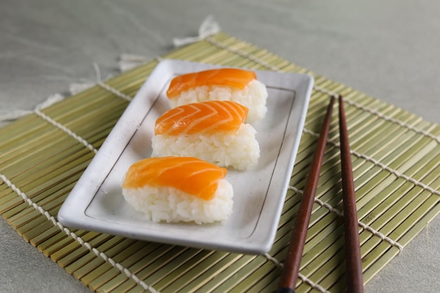 Fresh Salmon sushi nigiri served on ceramic plate