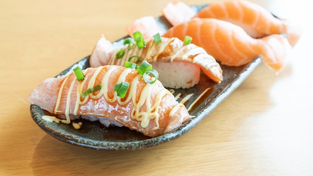 Fresh salmon sushi on a wooden table.