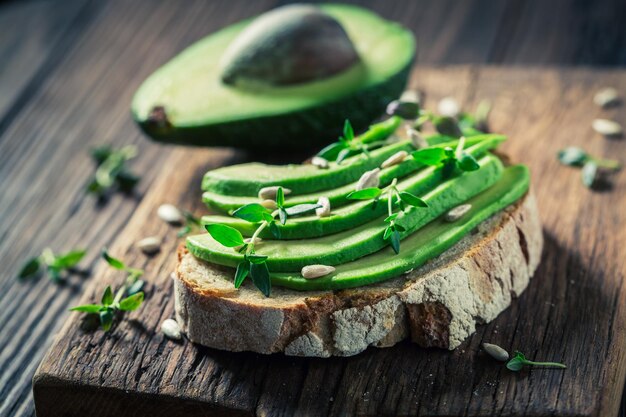 Fresh sandwich with avocado and herbs and seeds